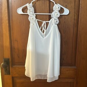 White V-neck blouse with lace and pearl straps